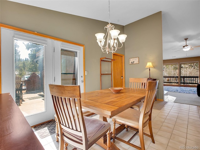 dining area featuring light tile patterned flooring and ceiling fan with notable chandelier