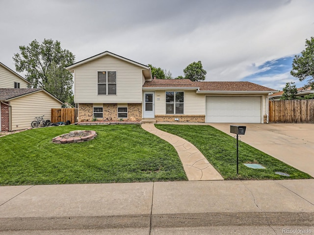 380 S 25th Ave, Brighton, CO 80601 - split level home featuring brick siding, concrete driveway, and a garage