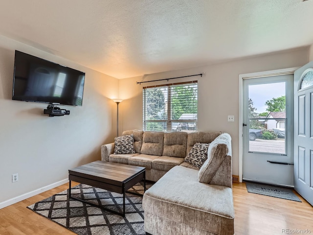 380 S 25th Ave, Brighton, CO 80601 - living area featuring light wood-style floors, baseboards, and a textured ceiling