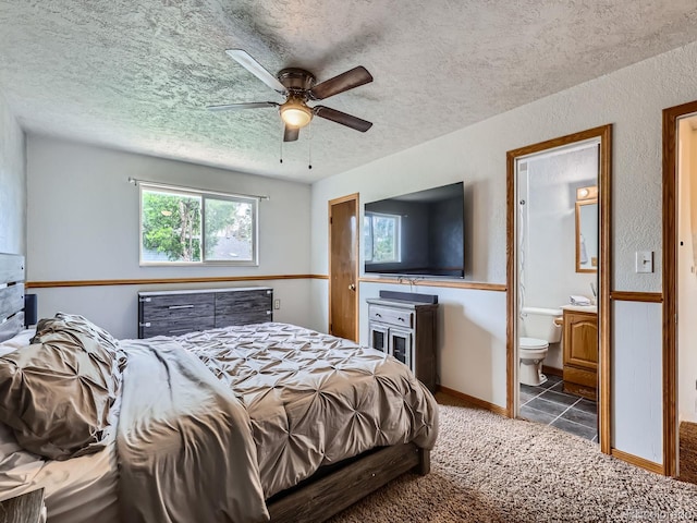 380 S 25th Ave, Brighton, CO 80601 - carpeted bedroom with a textured ceiling, ensuite bath, tile patterned flooring, and ceiling fan