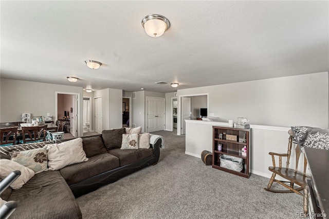 living area with carpet, visible vents, and baseboards