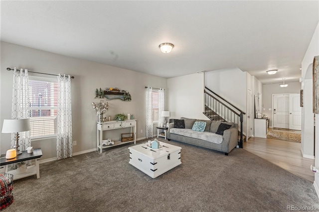carpeted living room with stairway and baseboards