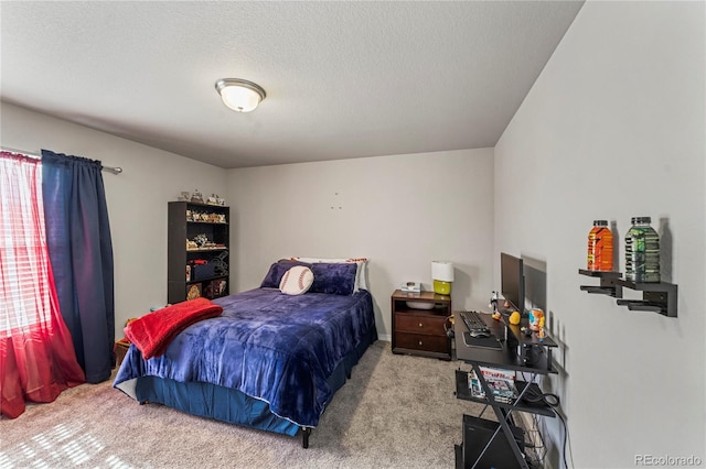 bedroom featuring carpet flooring and a textured ceiling