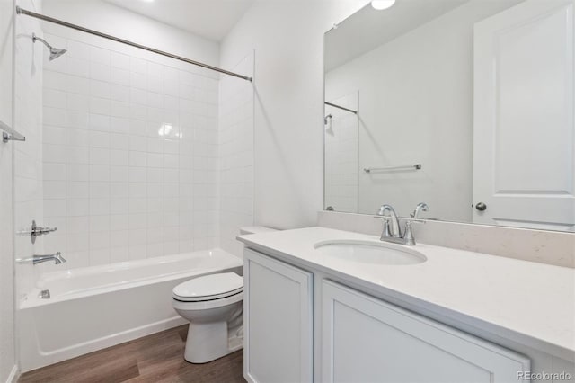 full bathroom with shower / tub combination, wood finished floors, vanity, and toilet