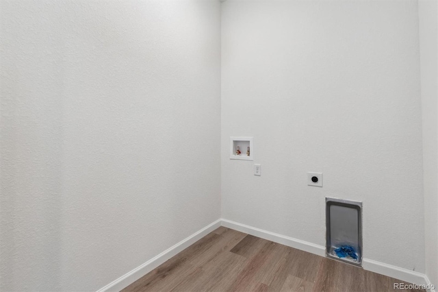 clothes washing area featuring electric dryer hookup, light wood-style floors, baseboards, laundry area, and washer hookup