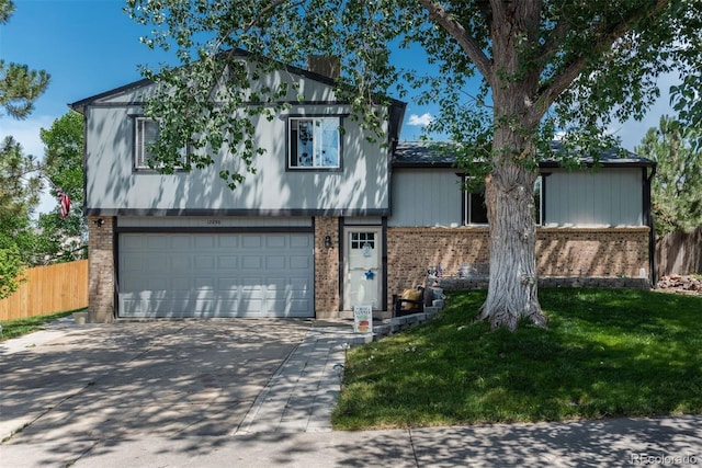 12296 Birch St, Thornton, CO 80241 - view of front of home with brick siding, a garage, and driveway
