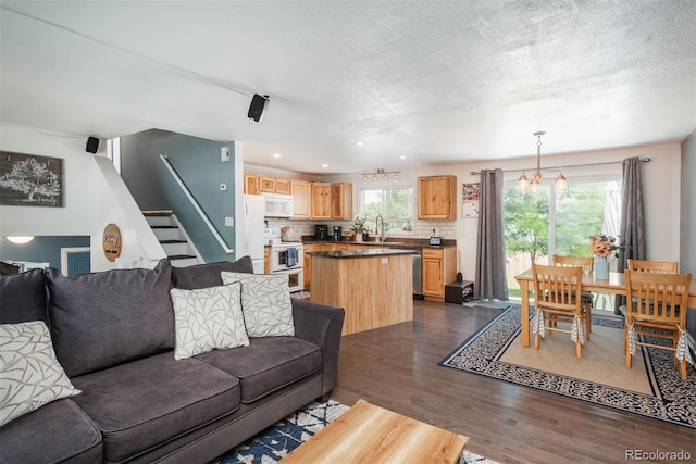 12296 Birch St, Thornton, CO 80241 - living area with dark wood-style flooring, stairway, recessed lighting, and a textured ceiling
