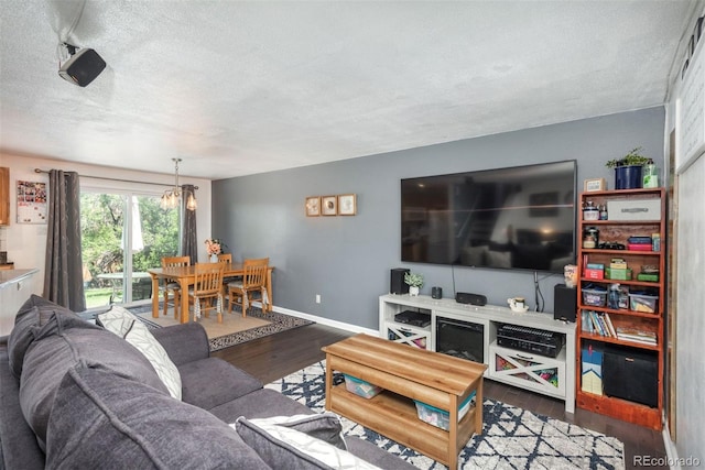 12296 Birch St, Thornton, CO 80241 - living area featuring wood finished floors, a textured ceiling, and a chandelier