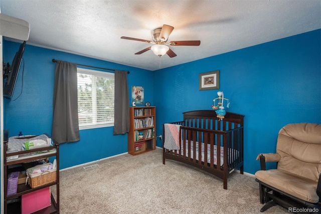 12296 Birch St, Thornton, CO 80241 - bedroom with carpet, ceiling fan, a crib, and a textured ceiling
