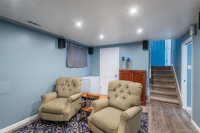 12296 Birch St, Thornton, CO 80241 - sitting room featuring wood finished floors, stairs, and recessed lighting