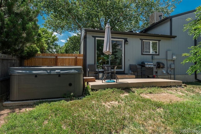 12296 Birch St, Thornton, CO 80241 - back of house featuring a hot tub and a patio area