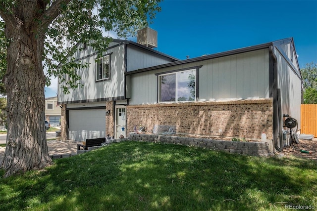 12296 Birch St, Thornton, CO 80241 - view of front of house with brick siding, a front yard, and an attached garage