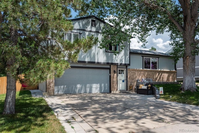 12296 Birch St, Thornton, CO 80241 - split level home featuring concrete driveway, brick siding, and a garage