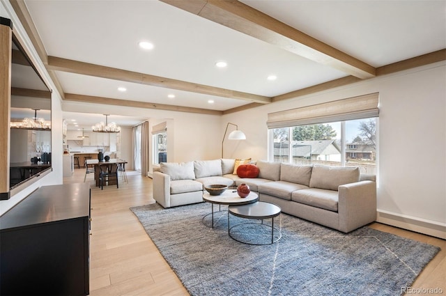 living room with light wood-type flooring, a chandelier, beam ceiling, and recessed lighting