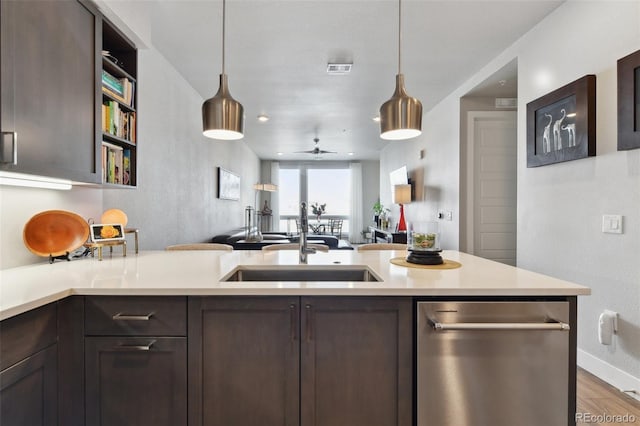 kitchen with dark brown cabinetry, sink, and stainless steel dishwasher