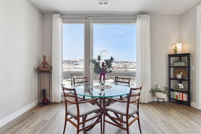 dining area with light hardwood / wood-style floors