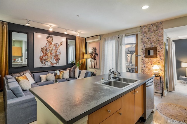 801 Confidence Dr Unit 2, Longmont, CO 80504 - kitchen featuring stainless steel dishwasher, dark countertops, a kitchen island with sink, open floor plan, and a wall mounted AC