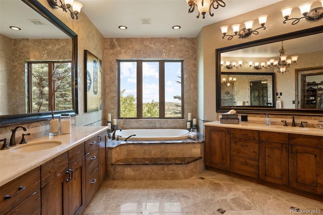 bathroom with tiled tub, a wealth of natural light, and vanity