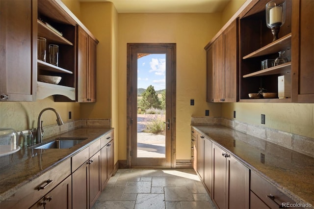 kitchen with sink and dark stone counters