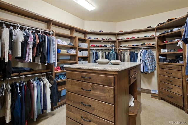 walk in closet featuring light colored carpet