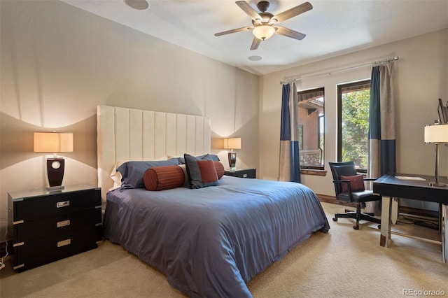 bedroom with ceiling fan and light carpet