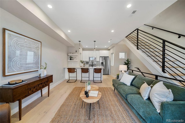 1473 N Locust, Denver, CO 80220 - living area with light wood finished floors, recessed lighting, and stairway