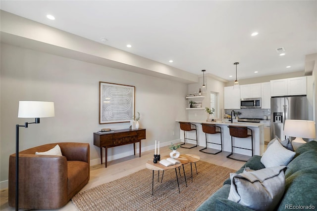 1473 N Locust, Denver, CO 80220 - living room with light wood-style floors and recessed lighting