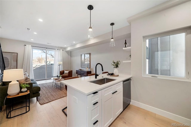 1473 N Locust, Denver, CO 80220 - kitchen featuring stainless steel dishwasher, open floor plan, a peninsula, light wood-type flooring, and recessed lighting