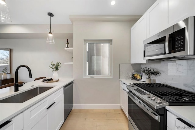 1473 N Locust, Denver, CO 80220 - kitchen with appliances with stainless steel finishes, decorative backsplash, white cabinets, light countertops, and recessed lighting