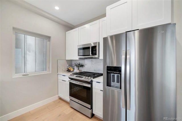 1473 N Locust, Denver, CO 80220 - kitchen with stainless steel appliances, light countertops, light wood-type flooring, decorative backsplash, and white cabinets