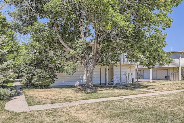 view of front of home with a garage and a front lawn