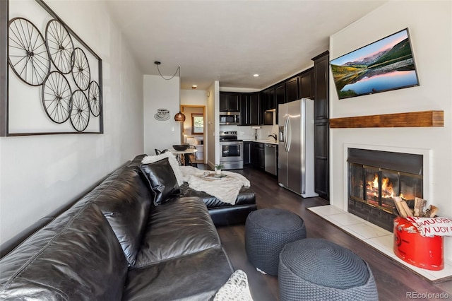 91400 Ryan Gulch Rd Unit 91406B, Silverthorne, CO 80498 - living area with dark wood-style floors and a tile fireplace