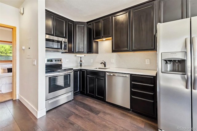91400 Ryan Gulch Rd Unit 91406B, Silverthorne, CO 80498 - kitchen featuring stainless steel appliances, light countertops, tasteful backsplash, and dark wood-type flooring
