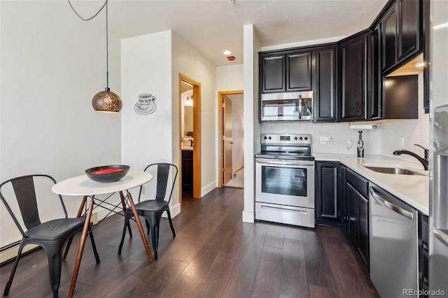 91400 Ryan Gulch Rd Unit 91406B, Silverthorne, CO 80498 - kitchen featuring stainless steel appliances, light countertops, dark wood finished floors, decorative backsplash, and dark cabinets