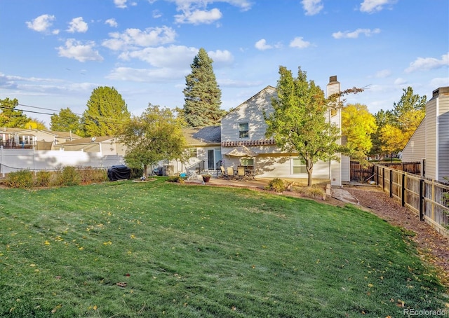 view of yard with a fenced backyard and a patio