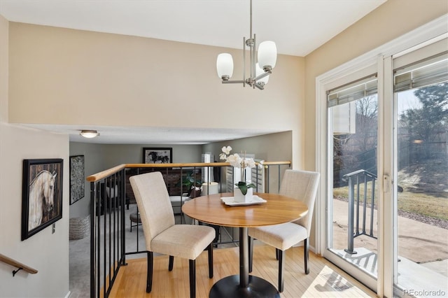 dining area featuring an inviting chandelier and light wood-style flooring