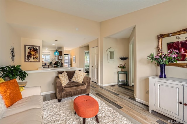 living room featuring baseboards and light wood finished floors