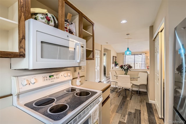 kitchen featuring recessed lighting, hanging light fixtures, white appliances, and wood finished floors