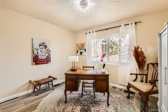 4028 Ames St, Wheat Ridge, CO 80212 - office space with wood finished floors, a textured ceiling, and baseboards
