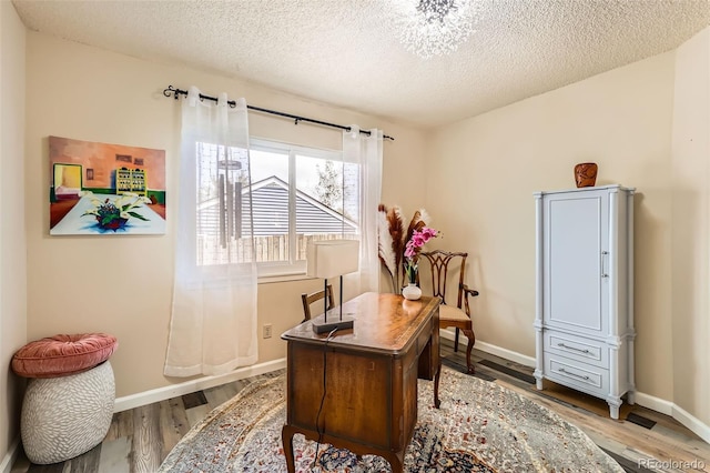 4028 Ames St, Wheat Ridge, CO 80212 - office with wood finished floors, a textured ceiling, and baseboards