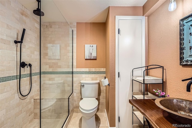 4028 Ames St, Wheat Ridge, CO 80212 - full bathroom featuring a stall shower, toilet, a textured wall, and vanity