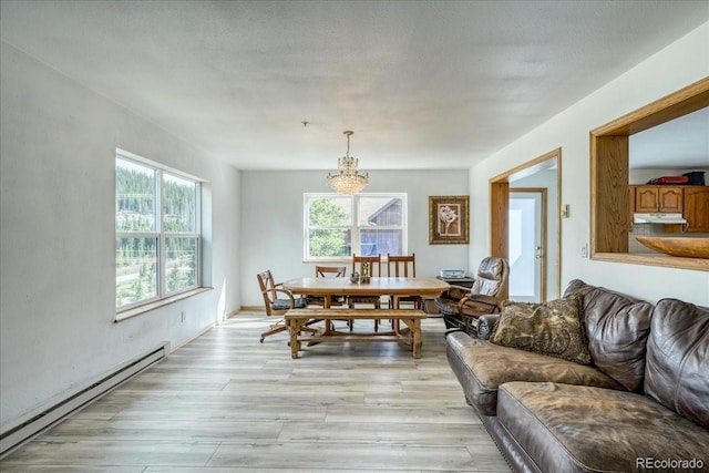 234 Carroll Ln, Breckenridge, CO 80424 - dining space with baseboard heating, a chandelier, and light wood-style floors