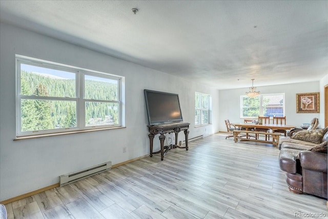 234 Carroll Ln, Breckenridge, CO 80424 - living area featuring baseboard heating, a chandelier, and light wood-style flooring