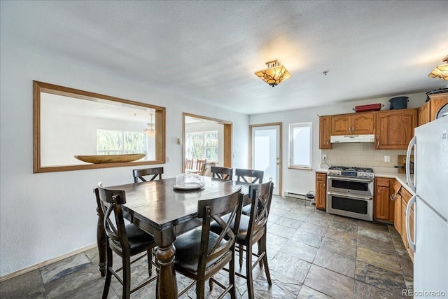 234 Carroll Ln, Breckenridge, CO 80424 - dining area with stone tile floors, baseboard heating, and a textured ceiling