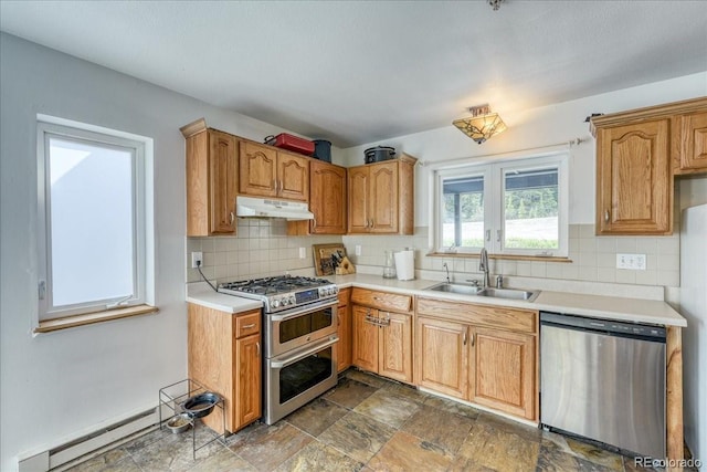 234 Carroll Ln, Breckenridge, CO 80424 - kitchen with stainless steel appliances, under cabinet range hood, a baseboard heating unit, decorative backsplash, and light countertops