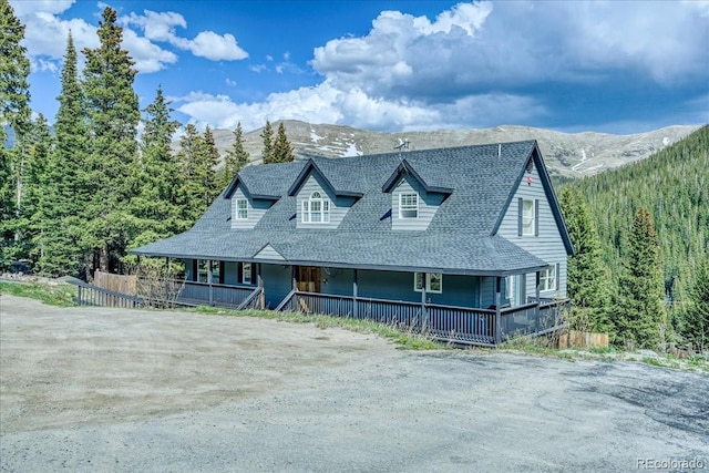 234 Carroll Ln, Breckenridge, CO 80424 - farmhouse featuring a porch, a mountain view, dirt driveway, and roof with shingles