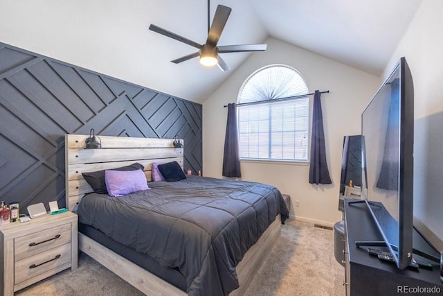 bedroom featuring carpet floors, lofted ceiling, an accent wall, and ceiling fan