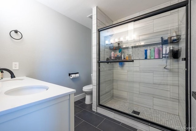 full bathroom with toilet, a stall shower, vanity, tile patterned flooring, and baseboards