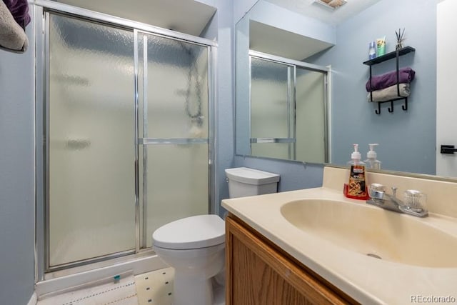 full bathroom with toilet, a shower stall, and vanity