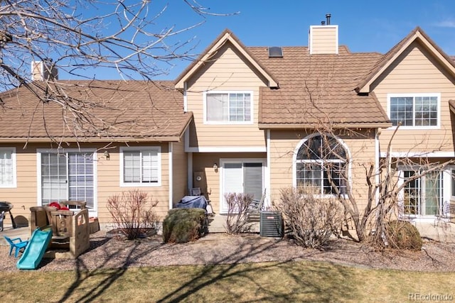 view of front of house with a chimney and a patio